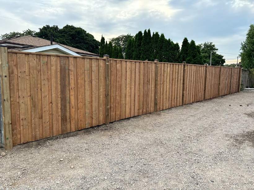 New cedar privacy fence installed along a Hamilton property